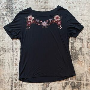 Dark navy floral top with embroidered flowers on the front, short sleeves.